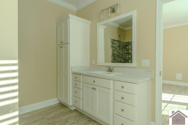631 Imogene Dr, Gilbertsville, KY 42044 - full bath featuring crown molding, tiled shower, vanity, baseboards, and wood finished floors