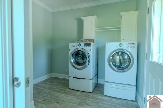 631 Imogene Dr, Gilbertsville, KY 42044 - laundry room with washing machine and clothes dryer, cabinet space, wood finished floors, baseboards, and crown molding
