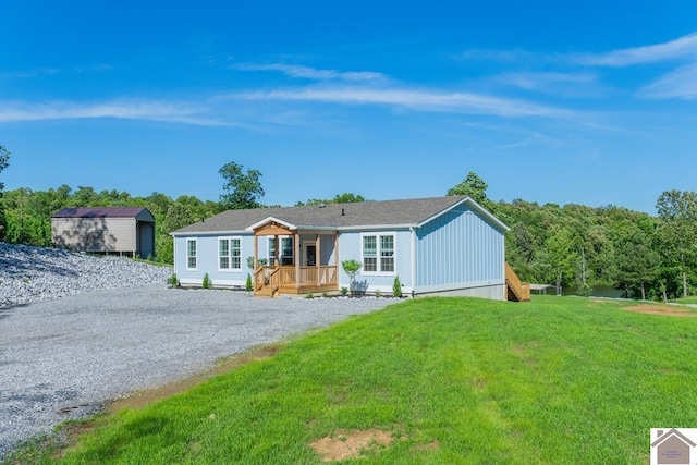 631 Imogene Dr, Gilbertsville, KY 42044 - ranch-style house with driveway, a front yard, and a wooden deck