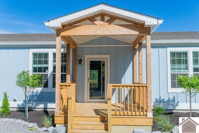 631 Imogene Dr, Gilbertsville, KY 42044 - doorway to property featuring board and batten siding and roof with shingles
