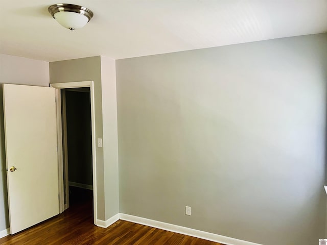 908 N 21st St, Paducah, KY 42001 - unfurnished bedroom with dark wood-type flooring and baseboards