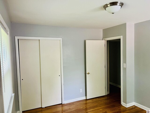 908 N 21st St, Paducah, KY 42001 - unfurnished bedroom with wood finished floors, a closet, and baseboards