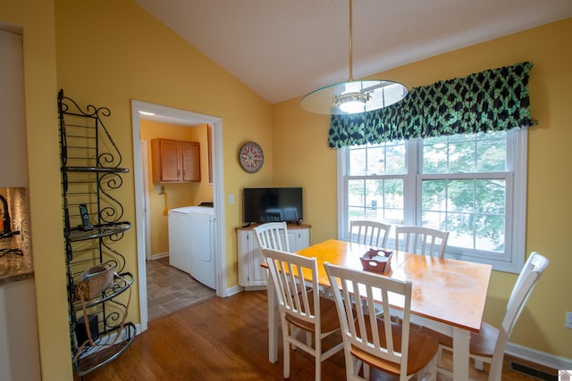 1055 Lakeview Dr, Paducah, KY 42003 - dining room featuring independent washer and dryer, vaulted ceiling, light wood-type flooring, and baseboards