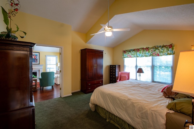 1055 Lakeview Dr, Paducah, KY 42003 - bedroom featuring lofted ceiling, dark colored carpet, a fireplace, and a ceiling fan