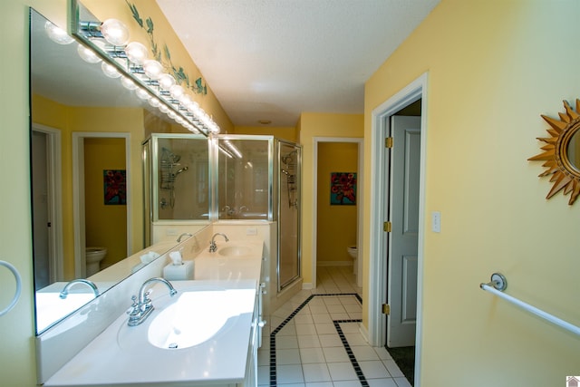 1055 Lakeview Dr, Paducah, KY 42003 - full bath featuring toilet, tile patterned floors, a shower stall, baseboards, and a textured ceiling