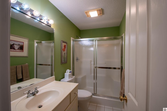 1055 Lakeview Dr, Paducah, KY 42003 - bathroom with a textured ceiling, a stall shower, tile patterned flooring, vanity, and toilet