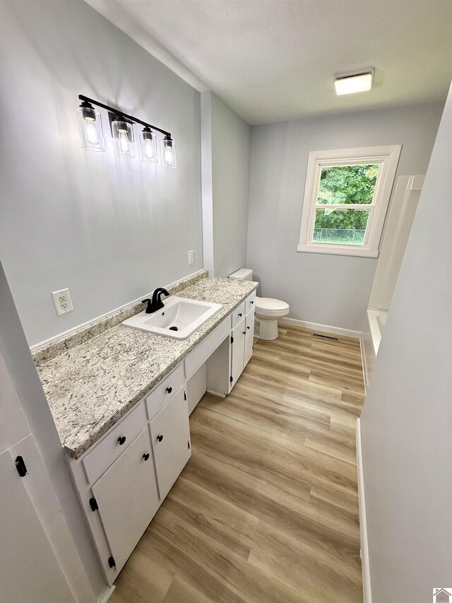 701 N 18th St, Murray, KY 42071 - bathroom with vanity, toilet, wood finished floors, and baseboards
