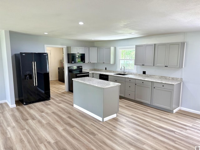701 N 18th St, Murray, KY 42071 - kitchen featuring black appliances, gray cabinetry, a sink, a center island, and baseboards