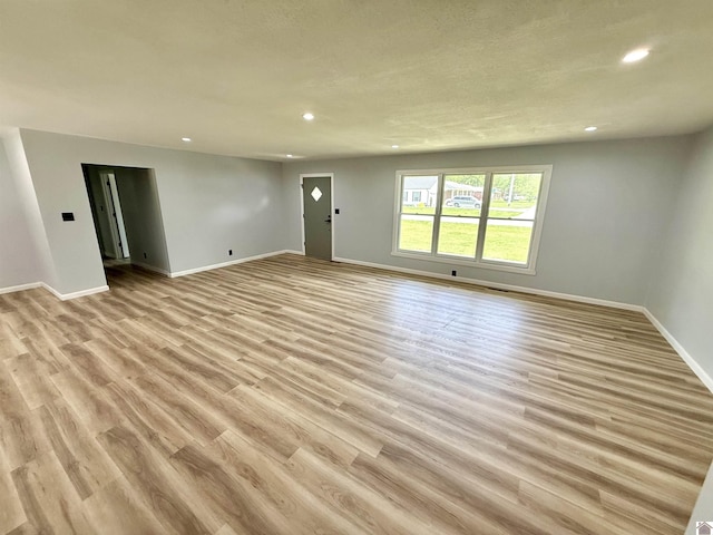 701 N 18th St, Murray, KY 42071 - unfurnished living room featuring recessed lighting, baseboards, and light wood-style flooring