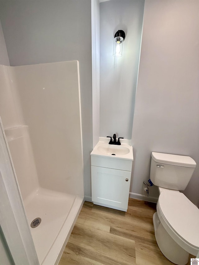 701 N 18th St, Murray, KY 42071 - full bath featuring wood finished floors, a stall shower, toilet, vanity, and baseboards