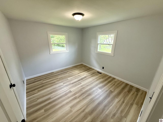 701 N 18th St, Murray, KY 42071 - unfurnished room featuring plenty of natural light, light wood-style floors, and baseboards
