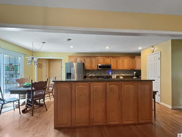 189 Edinborough W, Murray, KY 42071 - kitchen with appliances with stainless steel finishes, dark countertops, light wood finished floors, decorative backsplash, and a textured ceiling