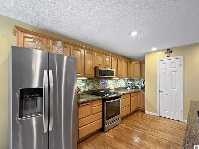 189 Edinborough W, Murray, KY 42071 - kitchen with appliances with stainless steel finishes, light wood-style flooring, tasteful backsplash, a textured ceiling, and recessed lighting