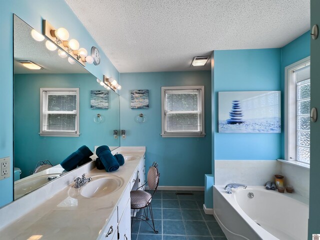 189 Edinborough W, Murray, KY 42071 - full bath with double vanity, a bath, healthy amount of natural light, a textured ceiling, and tile patterned floors