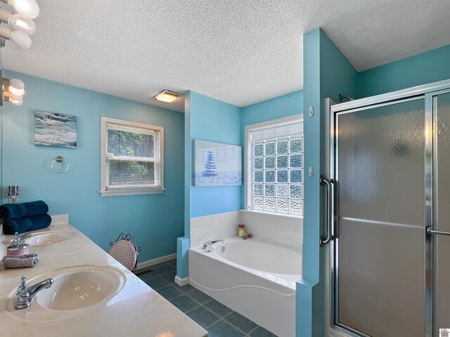 189 Edinborough W, Murray, KY 42071 - full bathroom with a bath, a stall shower, tile patterned floors, baseboards, and a textured ceiling