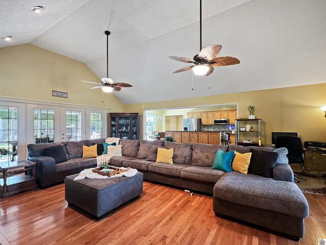 189 Edinborough W, Murray, KY 42071 - living room featuring ceiling fan, high vaulted ceiling, light wood-style floors, and a textured ceiling