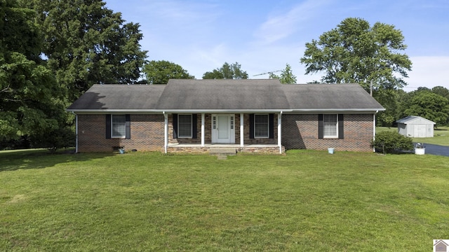 1158 State Route 295, Marion, KY 42064 - view of front of house with a porch, a front yard, a shingled roof, and brick siding