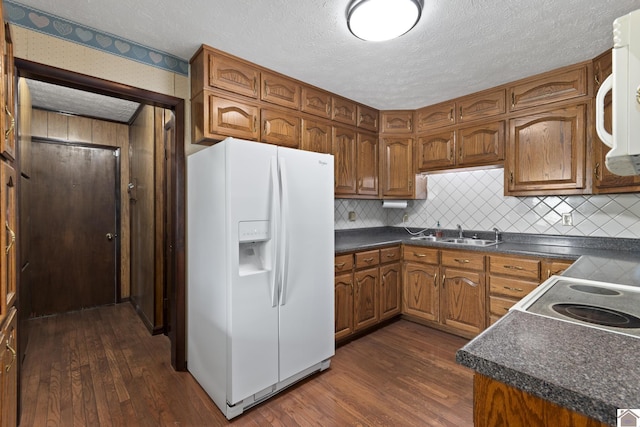 1158 State Route 295, Marion, KY 42064 - kitchen featuring white appliances, a sink, dark countertops, dark wood-type flooring, and a textured ceiling