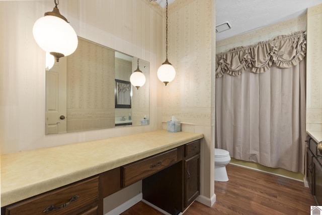 1158 State Route 295, Marion, KY 42064 - bathroom with vanity, wallpapered walls, toilet, wood finished floors, and shower / bath combo