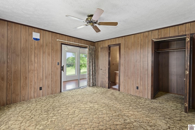 1158 State Route 295, Marion, KY 42064 - unfurnished bedroom with wood walls, carpet floors, a textured ceiling, a ceiling fan, and ornamental molding