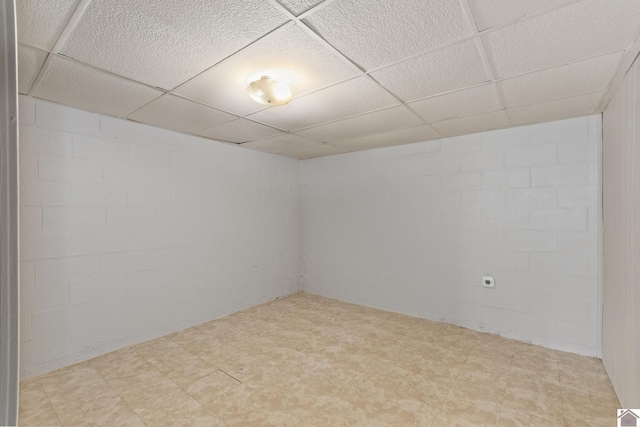 1158 State Route 295, Marion, KY 42064 - empty room featuring light flooring, a paneled ceiling, and concrete block wall