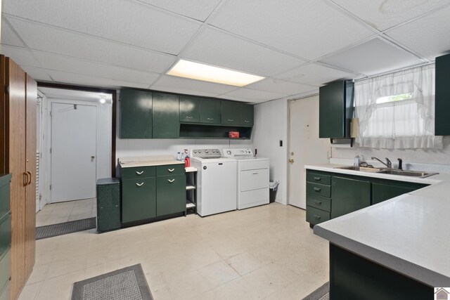 1158 State Route 295, Marion, KY 42064 - kitchen featuring green cabinets, a sink, washing machine and clothes dryer, a paneled ceiling, and light countertops