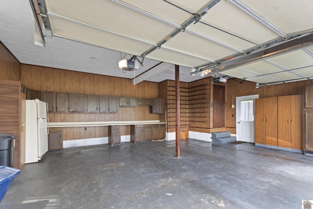 1158 State Route 295, Marion, KY 42064 - garage with freestanding refrigerator, wood walls, and a garage door opener