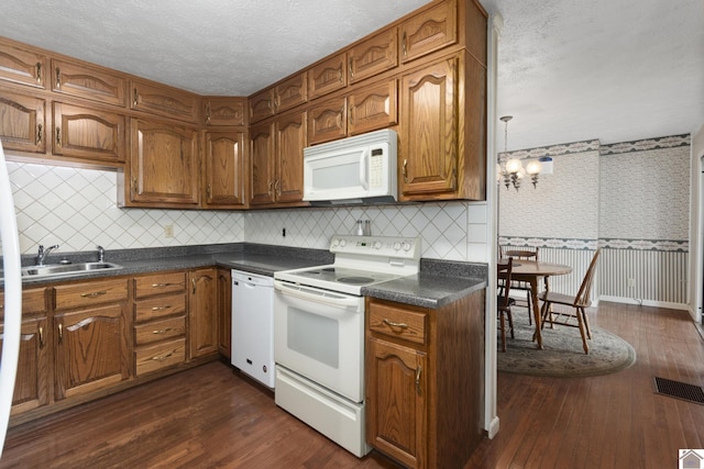 1158 State Route 295, Marion, KY 42064 - kitchen with white appliances, a sink, dark countertops, brown cabinetry, and dark wood-style floors