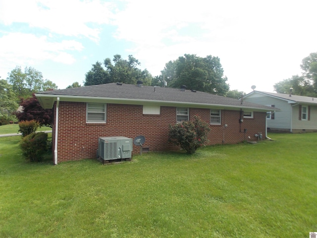 528 Elm, Clinton, KY 42031 - back of property with central AC unit, brick siding, and a lawn