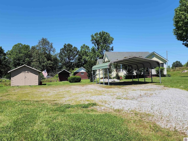 1691 Symsonia Hwy, Benton, KY 42025 - view of green lawn with driveway and a detached carport
