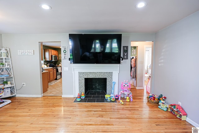 157 Calvert Dr, Paducah, KY 42003 - living area featuring light wood-style flooring, a tile fireplace, recessed lighting, and baseboards