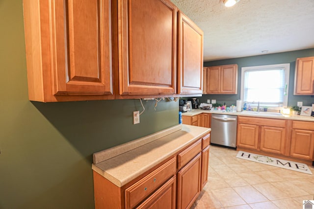 157 Calvert Dr, Paducah, KY 42003 - kitchen with dishwasher, a sink, light countertops, and a textured ceiling
