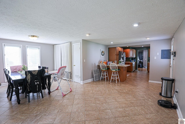 157 Calvert Dr, Paducah, KY 42003 - dining room featuring a textured ceiling, baseboards, and light tile patterned floors