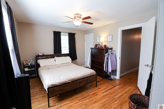 157 Calvert Dr, Paducah, KY 42003 - bedroom with light wood finished floors, a ceiling fan, and baseboards
