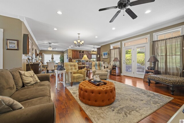 124 Hughes Rd, Benton, KY 42025 - living room featuring a ceiling fan, a chandelier, ornamental molding, plenty of natural light, and dark wood-style flooring