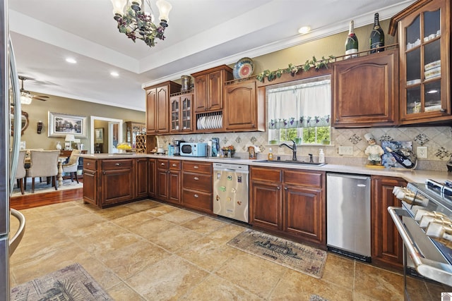 124 Hughes Rd, Benton, KY 42025 - kitchen featuring stainless steel appliances, a sink, a peninsula, light countertops, and ornamental molding