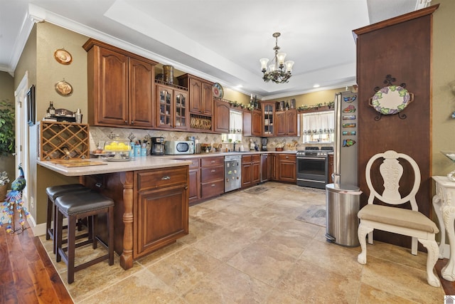 124 Hughes Rd, Benton, KY 42025 - kitchen featuring stainless steel appliances, crown molding, a peninsula, a chandelier, and backsplash