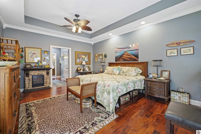 124 Hughes Rd, Benton, KY 42025 - bedroom with wood finished floors, crown molding, a tray ceiling, a fireplace, and recessed lighting