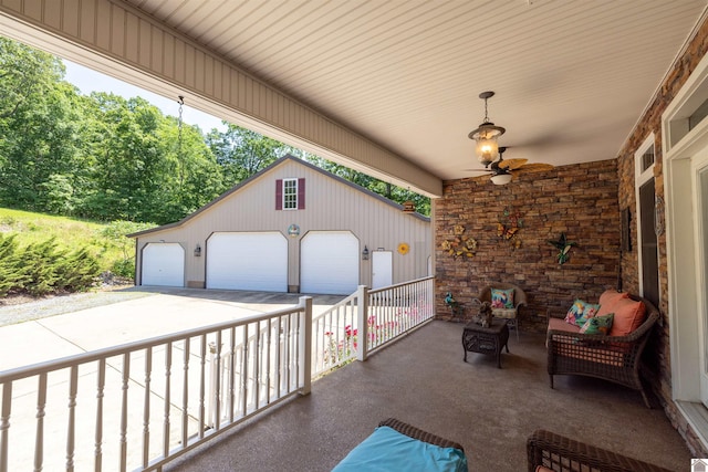 124 Hughes Rd, Benton, KY 42025 - view of patio featuring a detached garage, an outbuilding, and a ceiling fan