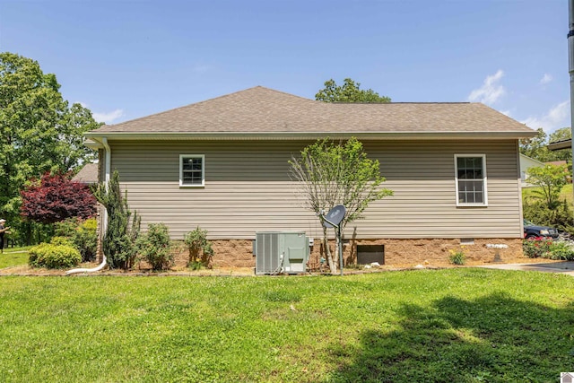 124 Hughes Rd, Benton, KY 42025 - view of home's exterior featuring central air condition unit, a yard, and roof with shingles