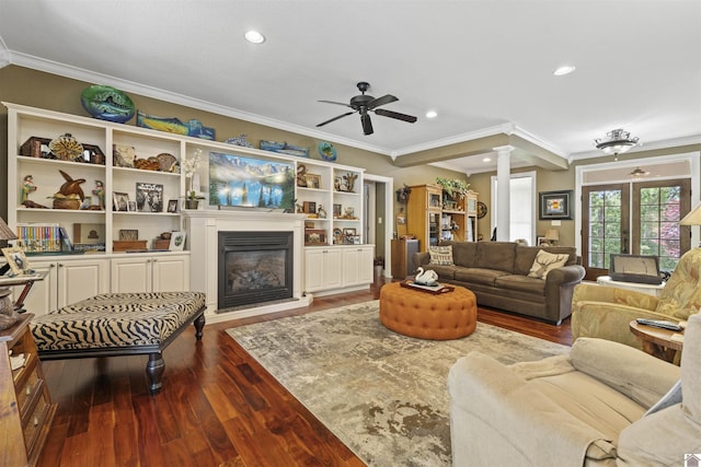 124 Hughes Rd, Benton, KY 42025 - living room with ornate columns, ornamental molding, dark wood-type flooring, a ceiling fan, and a glass covered fireplace