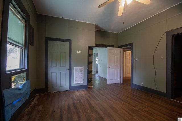 2310 S 28th, Paducah, KY 42003 - unfurnished bedroom featuring wood finished floors, multiple windows, and a ceiling fan