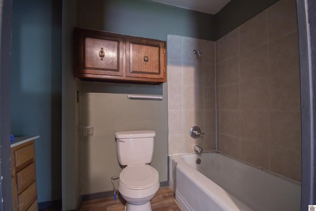 2310 S 28th, Paducah, KY 42003 - bathroom featuring toilet, washtub / shower combination, wood finished floors, and vanity