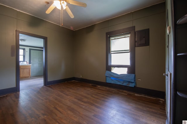 2310 S 28th, Paducah, KY 42003 - empty room with electric panel, dark wood-type flooring, ceiling fan, and baseboards