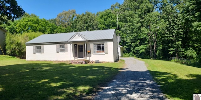 135 Phipps St, Paducah, KY 42001 - view of front facade featuring entry steps, a front yard, gravel driveway, and metal roof