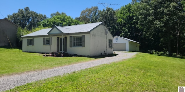 135 Phipps St, Paducah, KY 42001 - ranch-style home featuring a front yard, a garage, metal roof, and an outdoor structure