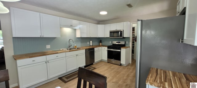 135 Phipps St, Paducah, KY 42001 - kitchen with stainless steel appliances, a sink, wooden counters, light wood finished floors, and recessed lighting