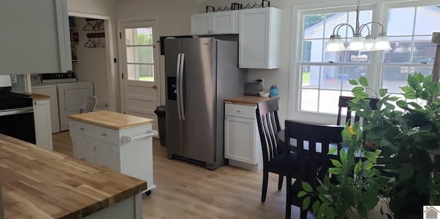 135 Phipps St, Paducah, KY 42001 - kitchen featuring butcher block countertops, washer and clothes dryer, stainless steel appliances, a chandelier, and light wood-style flooring