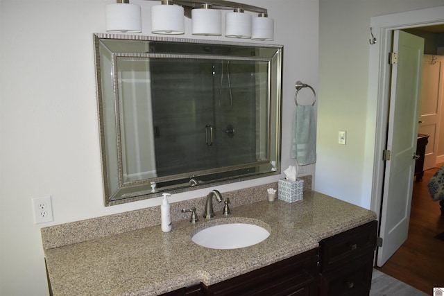 3975 Contest Rd, Paducah, KY 42001 - bathroom featuring vanity, wood finished floors, and an enclosed shower