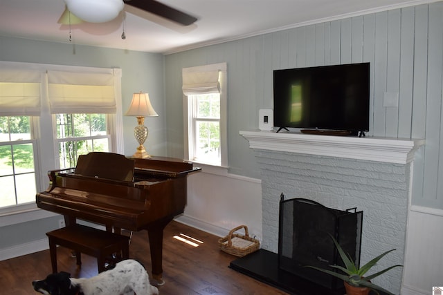 3975 Contest Rd, Paducah, KY 42001 - sitting room with ornamental molding, wood finished floors, ceiling fan, baseboards, and a brick fireplace